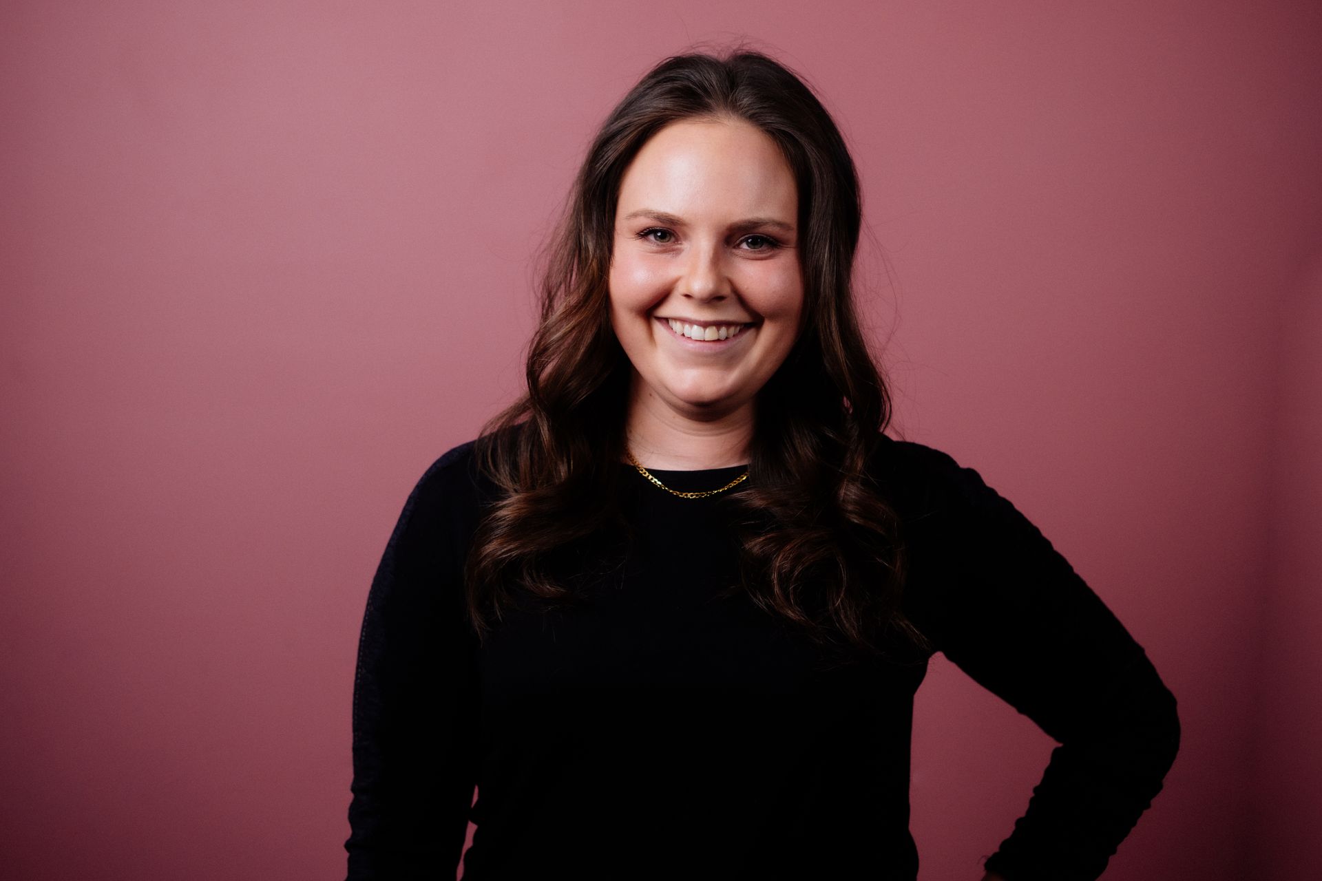 Sharon, hairstylist at Collective Haus smiling happily into the camera.