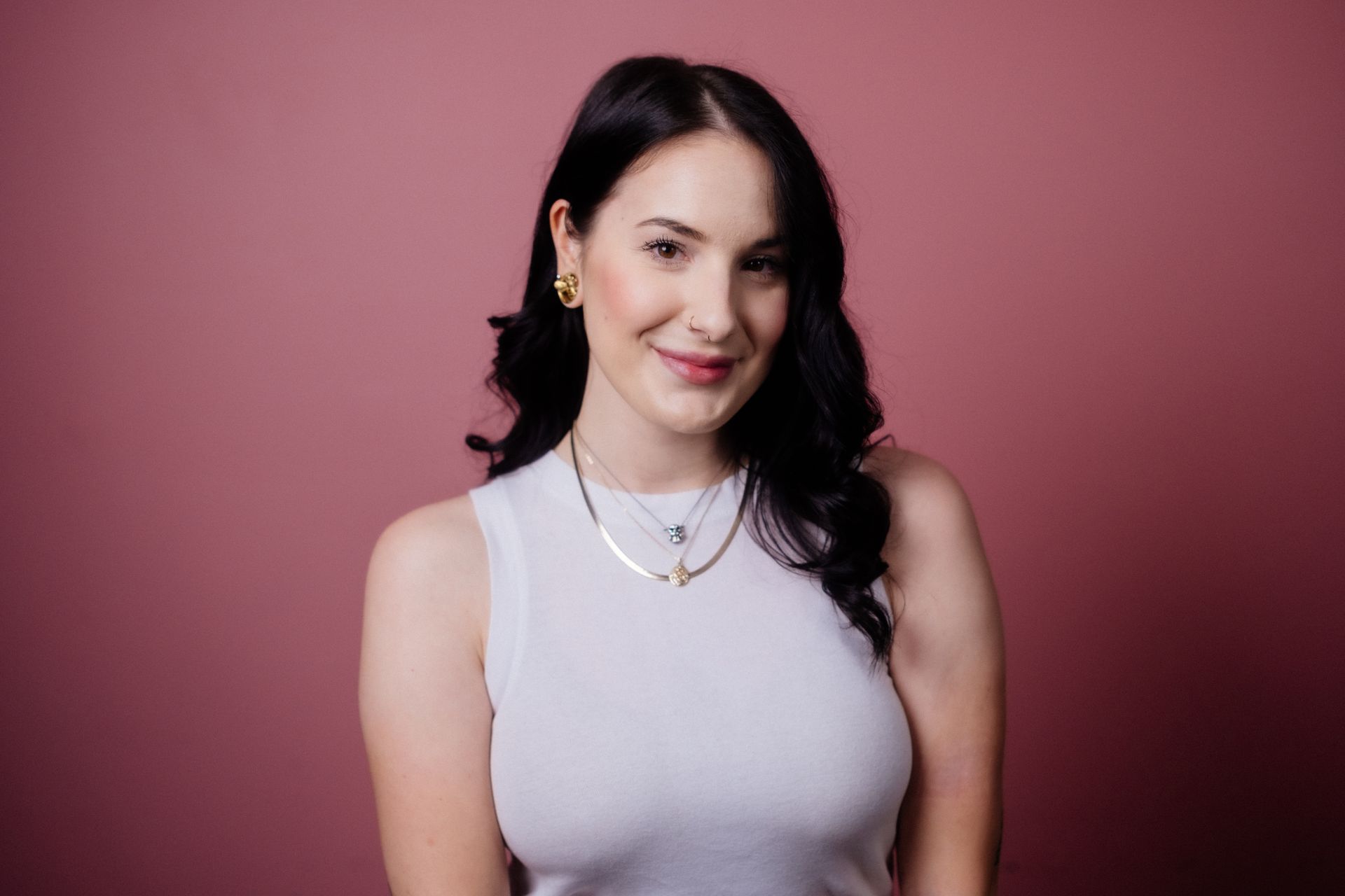 Victoria, hairstylist, compassionate vegan and resident cyclist at Collective Haus smiles looking into the camera